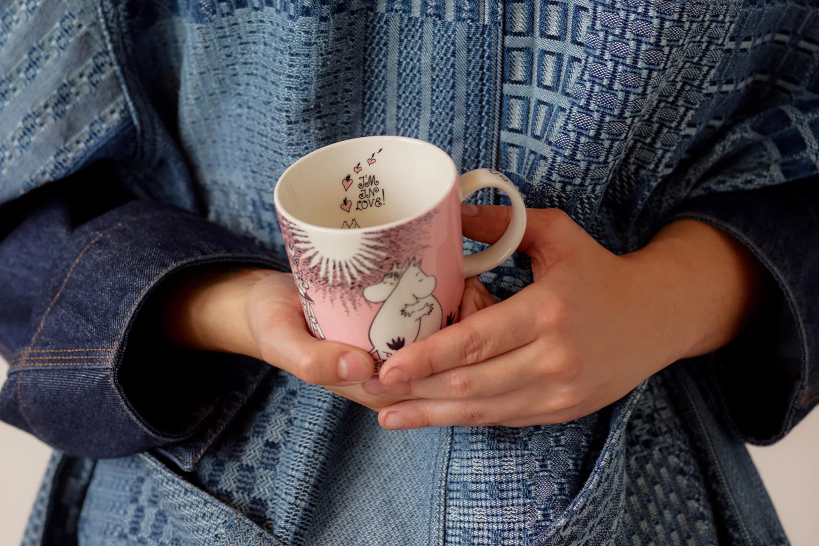 A women holding the Love 30 anniversary mug.