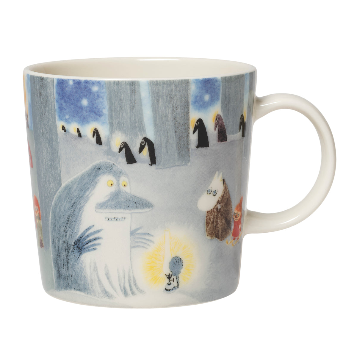 A white ceramic mug featuring a colorful illustration of the Groke, Moomintroll and Little My in a snowy forest scene.