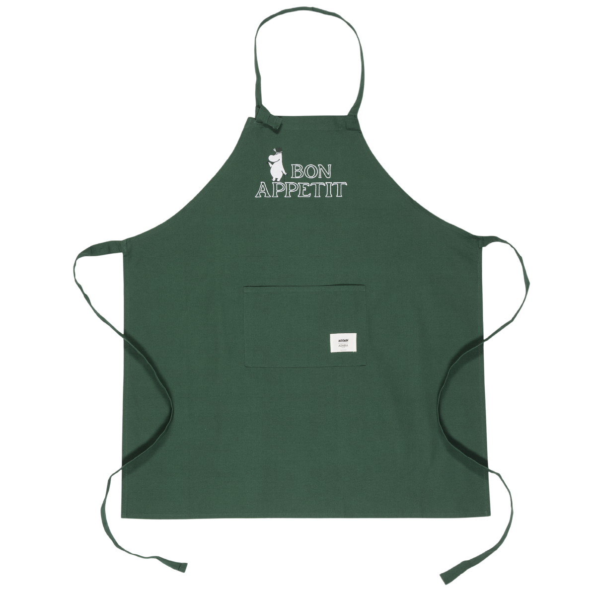 A dark green apron with a neck strap and waist ties, featuring a front pocket and a white graphic print on the chest that reads 'BON APPETIT' with a Moominpappa illustration. A small white brand tag is visible on the pocket.