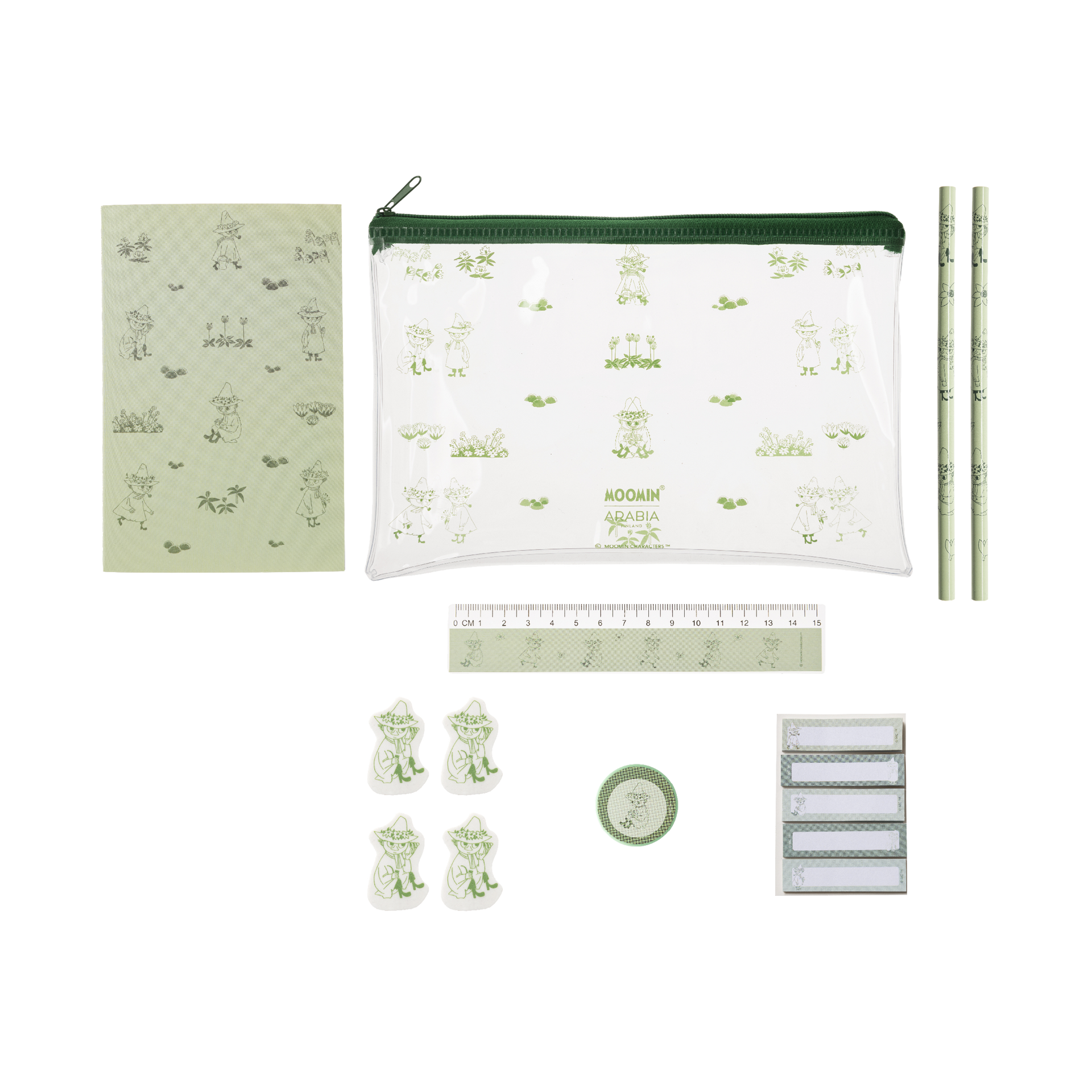 A stationery set laid out on a white background, including a clear zip pouch with a green zipper and pale green Snufkin illustrations, a matching notebook, two pencils, a ruler, four frog-shaped clips, a small round green item, and a stack of white labels. 
