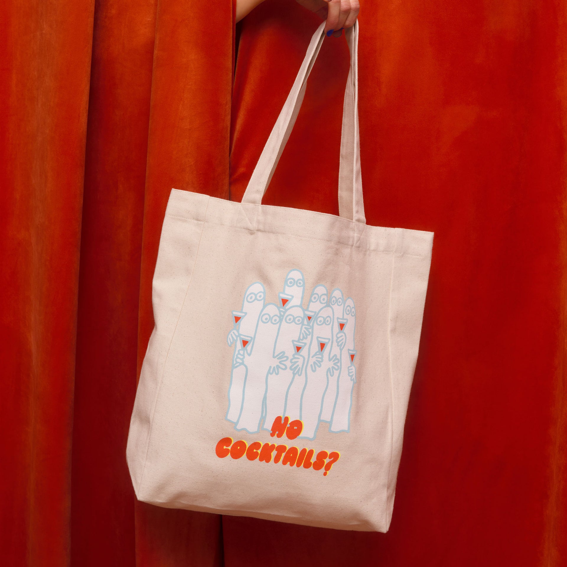 Moomin tote bag Party Queue - Beige Party Queue tote bag held by a person against a red curtain background