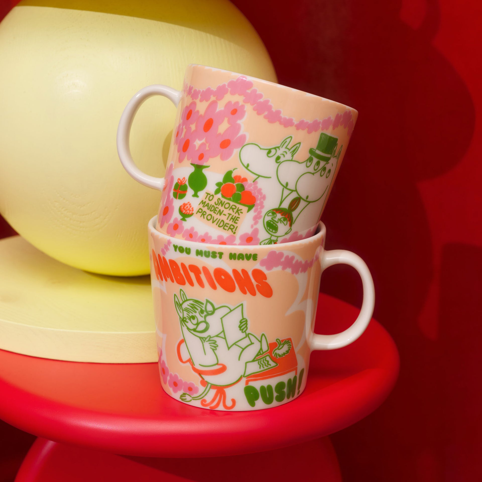 Moomin mug 0,4L Boss Lady - Two Boss Lady mugs on a red stool against a red background