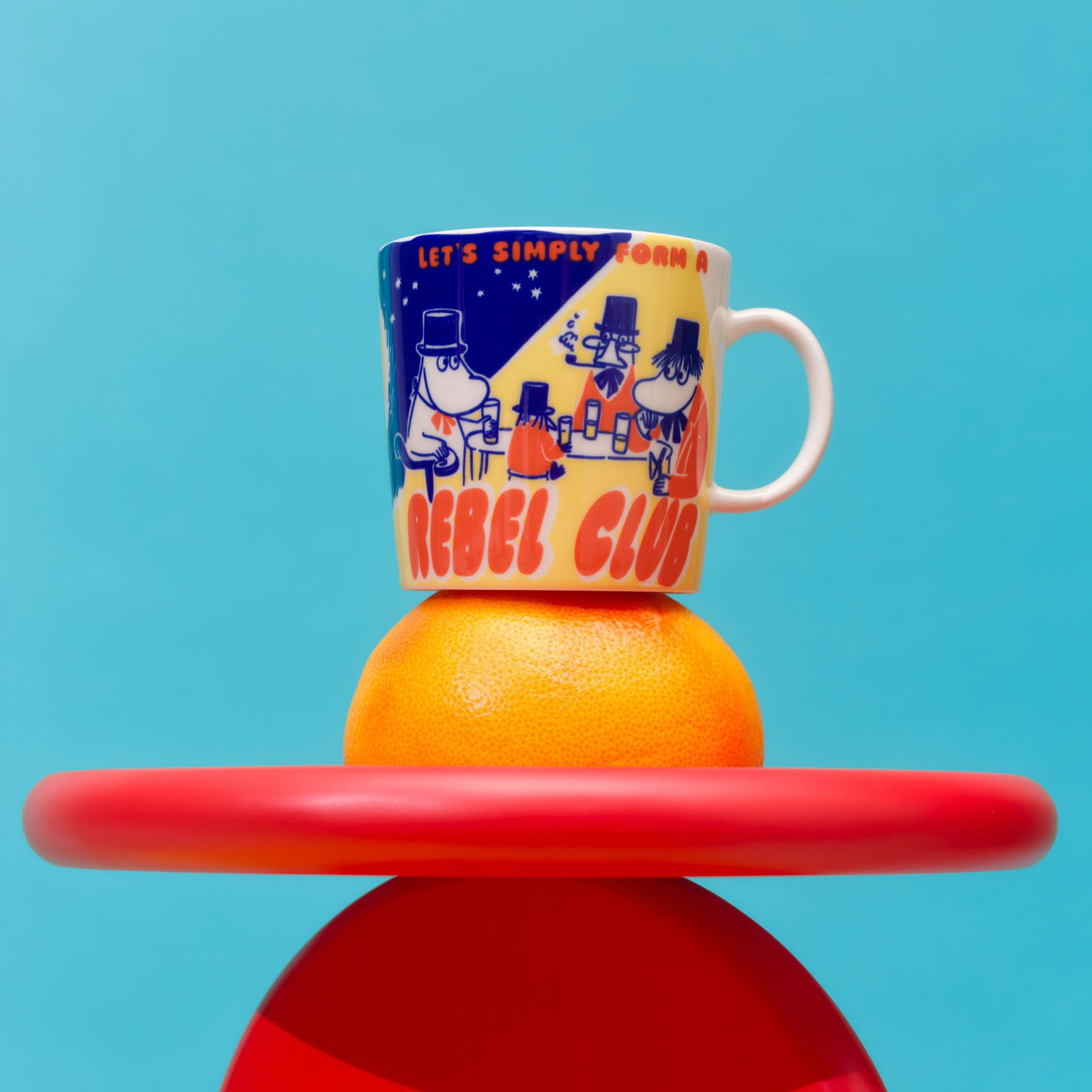 Rebel Club mug on an orange against a blue background