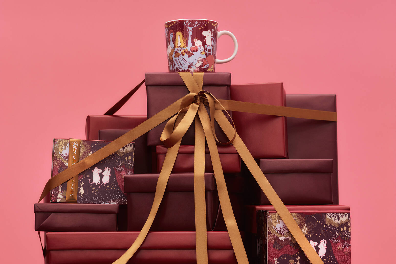 Stack of red gift boxes with a moomin Festive moments -mug on top