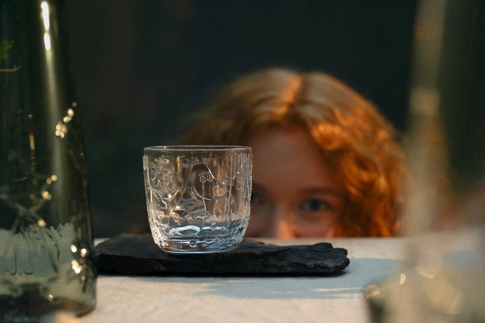 Clear Mystical forest -glass on a dark surface with a blurred person in the background