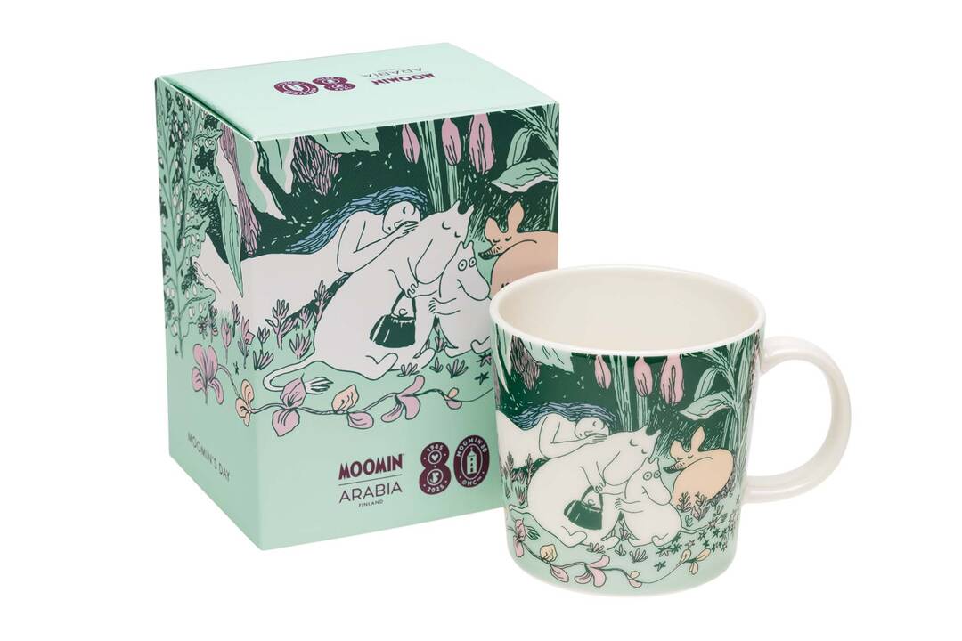 Moomin Day 2025 mug and packaging with a green design and anniversary logo on a white background