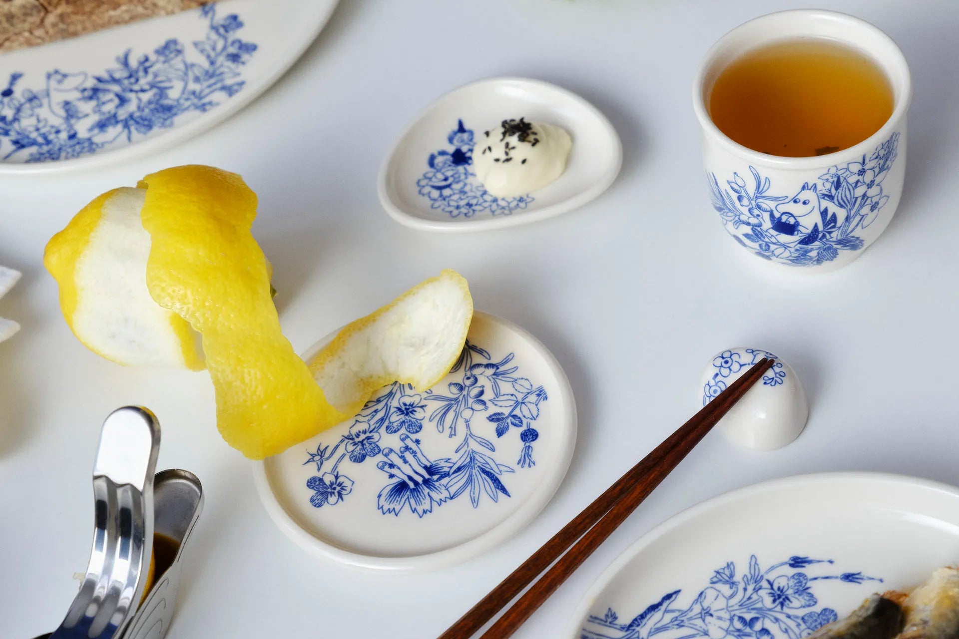 Haru tea set with tea cup, plates, and food on a white surface